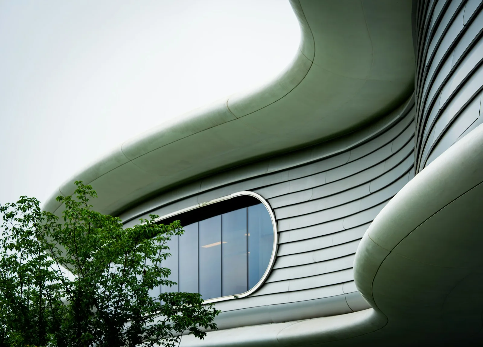 Contemporary white architecture with curved facades and generous glazing
